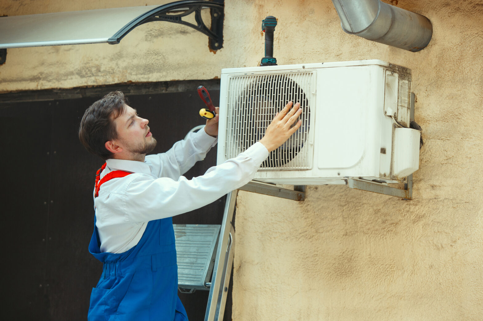 hvac technician working capacitor part condensing unit male worker repairman uniform repairing adjusting conditioning system diagnosing looking technical issues scaled hvac technician working capacitor part condensing unit male worker repairman uniform repairing adjusting conditioning system diagnosing looking technical issues scaled